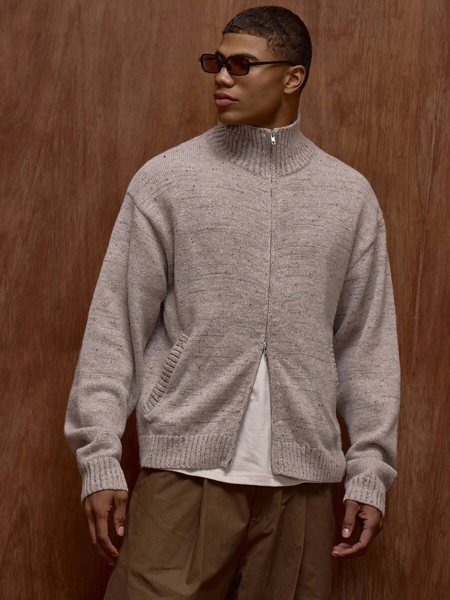 Zippered knit sweater with a stand‑up collar and a patterned design.