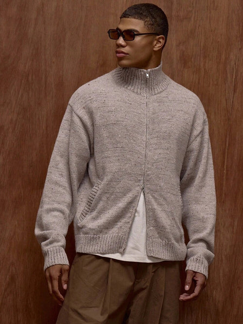 Zippered knit sweater with a stand‑up collar and a patterned design.