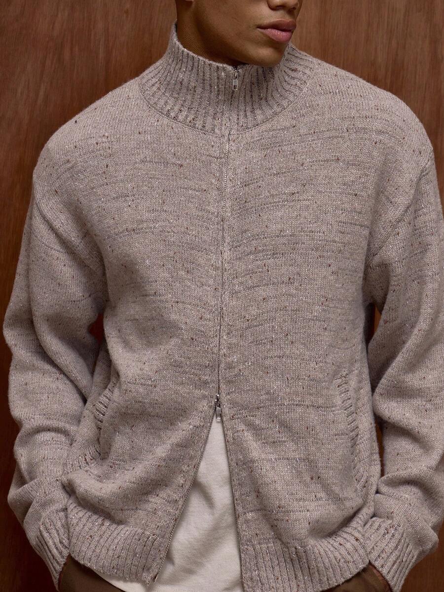 Zippered knit sweater with a stand‑up collar and a patterned design.