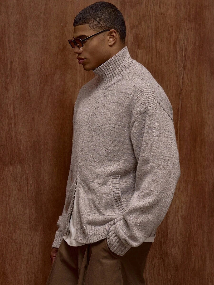 Zippered knit sweater with a stand‑up collar and a patterned design.