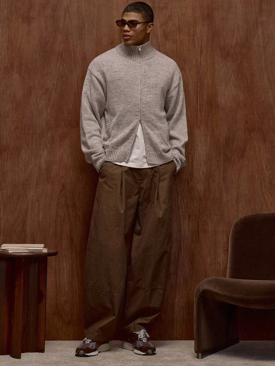 Zippered knit sweater with a stand‑up collar and a patterned design.