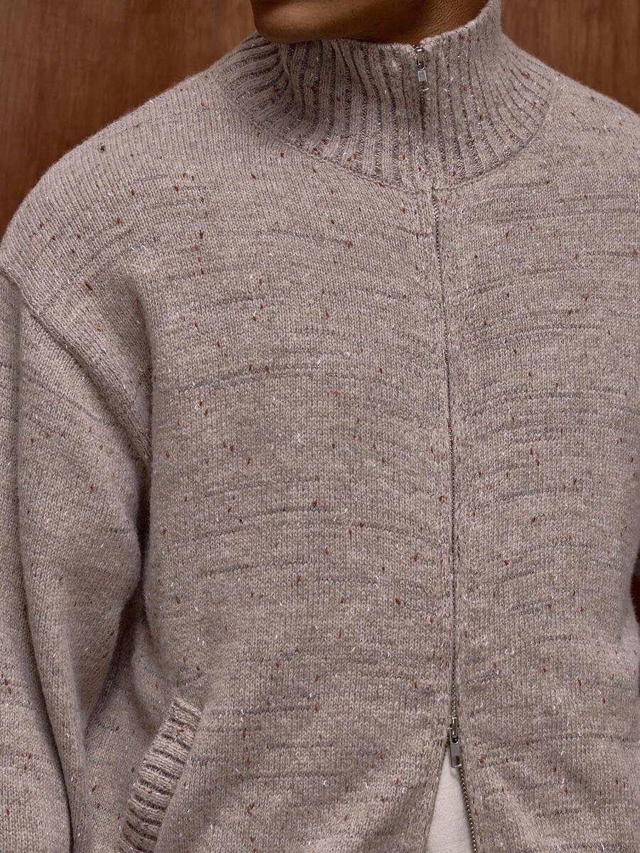 Zippered knit sweater with a stand‑up collar and a patterned design.